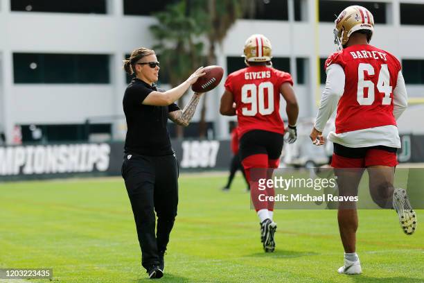 Offensive assistant coach Katie Sowers of the San Francisco 49ers runs a drill during practice for Super Bowl LIV at the Greentree Practice Fields on...