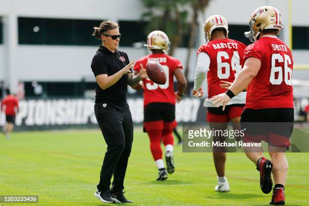Offensive assistant coach Katie Sowers of the San Francisco 49ers runs a drill during practice for Super Bowl LIV at the Greentree Practice Fields on...