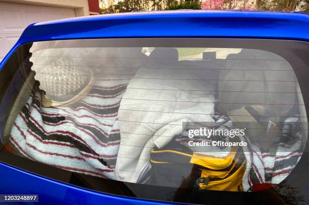 car packed with lots of things ready for the roadtrip - messy car interior stock pictures, royalty-free photos & images