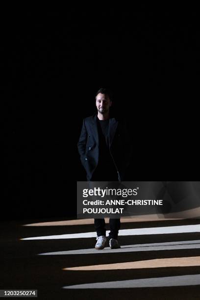 Belgian fashion designer for Yves Saint Laurent, Anthony Vaccarello, acknowledges the audience at the of the Women's Fall-Winter 2020-2021...