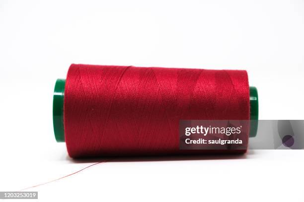 close-up of dark red spool of thread against white - 糸巻き ストックフォトと画像