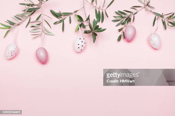 easter composition with olive branch and easter decoration on pastel pink background - easter stock pictures, royalty-free photos & images