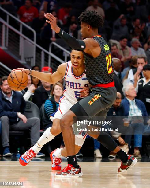 Zhaire Smith of the Philadelphia 76ers drives to the basket as Cam Reddish of the Atlanta Hawks defends during the first half of an NBA game at State...