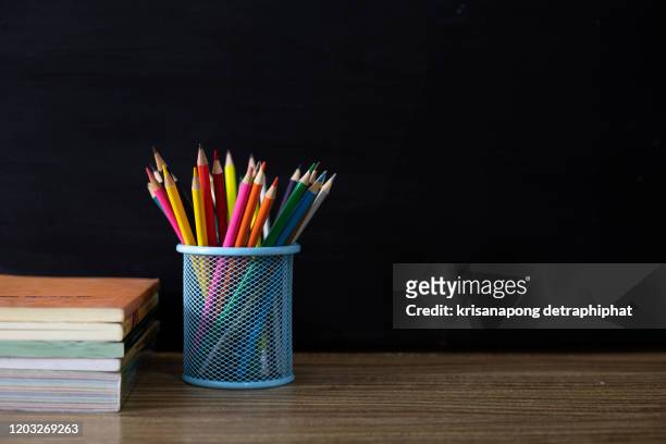 back to school supplies. books and blackboard on wooden background - pen mockup stock pictures, royalty-free photos & images