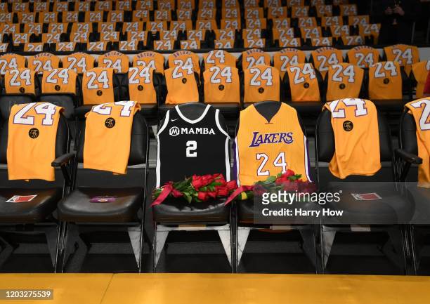 The Los Angeles Lakers honor Kobe Bryant and daughter Gigi by covering the courtside seats they occupied with flowers, Gigi's Mamba jersey and Kobe's...