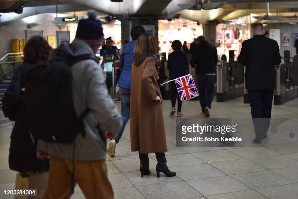 Woman holds Union Jack flags at Westminster station on the night the Leave Means Leave, Brexit day celebration party outside the Houses of Parliament...