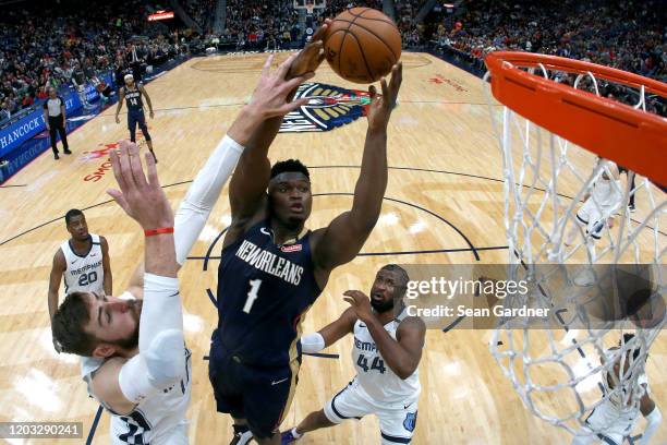 Zion Williamson of the New Orleans Pelicans shoots over Jonas Valanciunas of the Memphis Grizzlies during a NBA game at Smoothie King Center on...