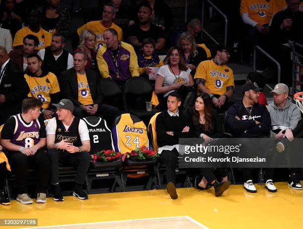 Javier "Chicharito" Hernandez and guest sit next to the courtside seats the Los Angeles Lakers honored for Kobe Bryant and daughter Gigi by covering...