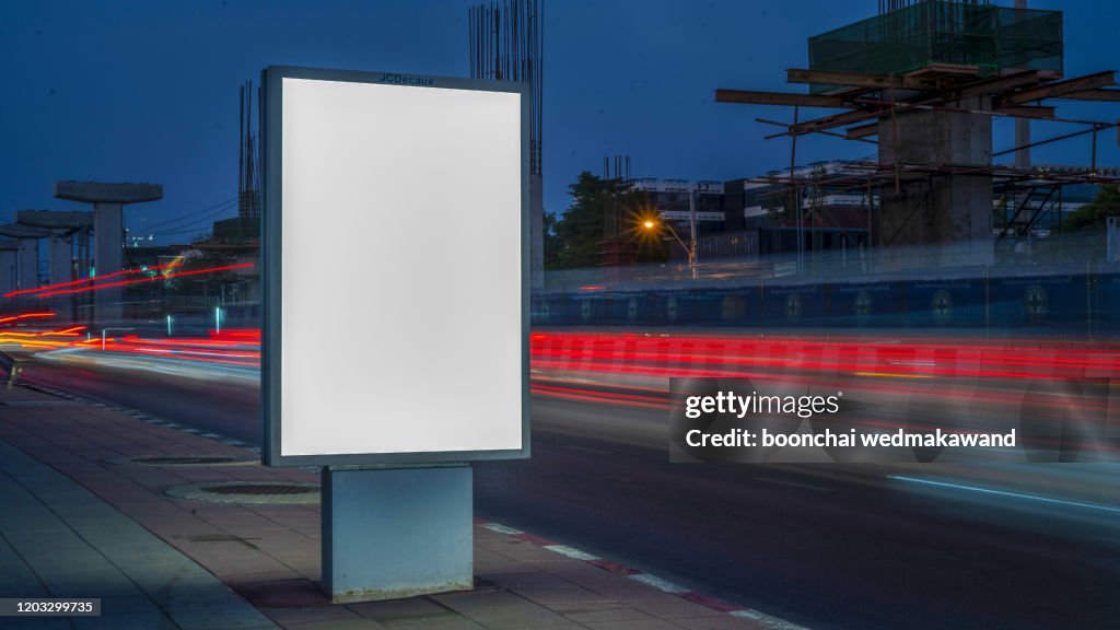 Blank Billboard on City Street at Night. Outdoor advertising