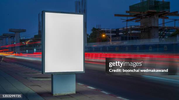 blank billboard on city street at night. outdoor advertising - bus poster imagens e fotografias de stock