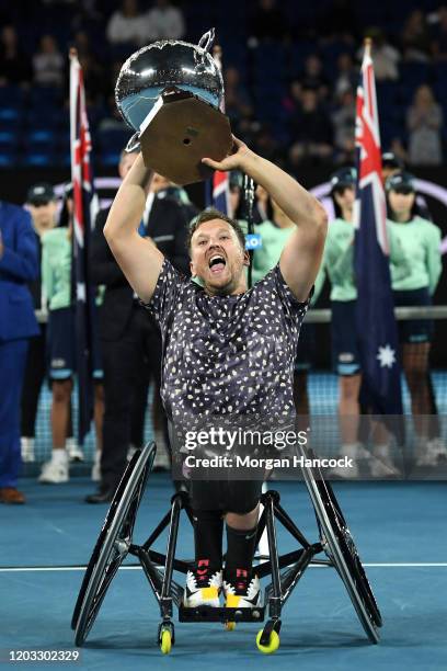 Dylan Alcott of Australia holds aloft the championship trophy following his Quad Wheelchair Singles Final match against Andy Lapthorne of Great...