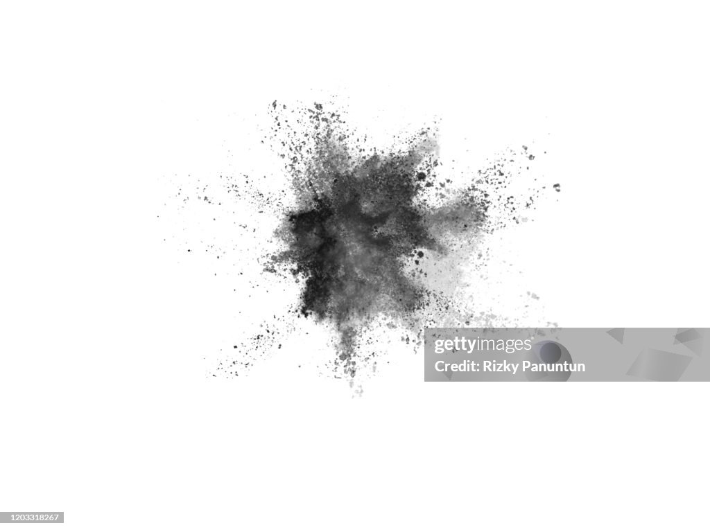 Close-Up Of Black Powder Splashing Against White Background