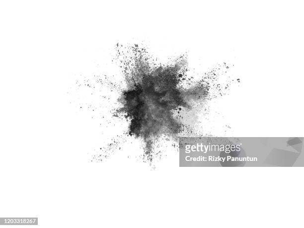 close-up of black powder splashing against white background - cinerea foto e immagini stock