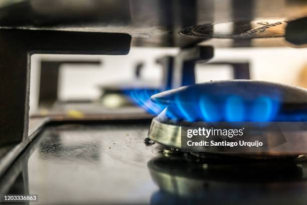 close-up of gas stove burner and pot - close up cooking stock-fotos und bilder