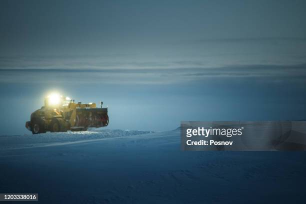 snowplow truck cleaning snow at nordkinn peninsula near gamvik - snow plow stock pictures, royalty-free photos & images