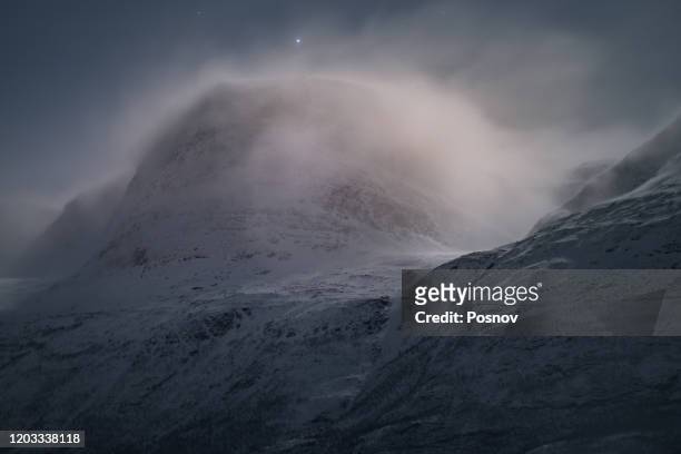 strong wind and blizzard on top of the mountain at lyngen alps - blizzard bildbanksfoton och bilder