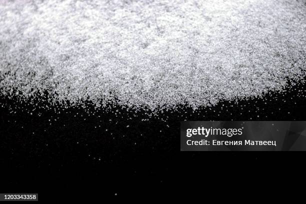 abstract wallpaper design of white color shiny snow dust powder isolated on black background - powder snow imagens e fotografias de stock