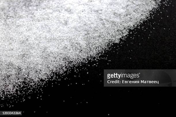 abstract wallpaper design of white color shiny snow dust powder isolated on black background - powder snow fotografías e imágenes de stock