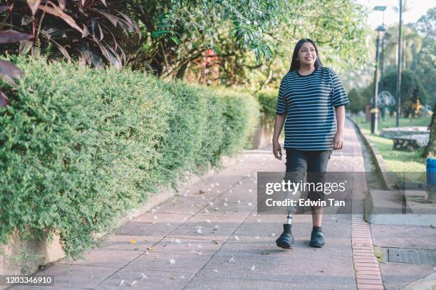 an asian indian handicapped with prosthetic leg sport woman jogging in the public park morning session - amputee woman imagens e fotografias de stock