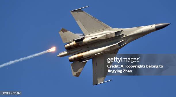 the moment of a chinese air force fighter launching jamming bombs - rocket engine stock pictures, royalty-free photos & images