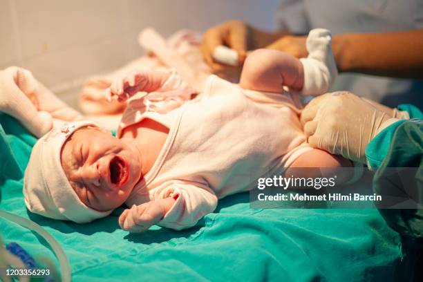 newborn baby crying minutes after birth - baby blanket stock pictures, royalty-free photos & images
