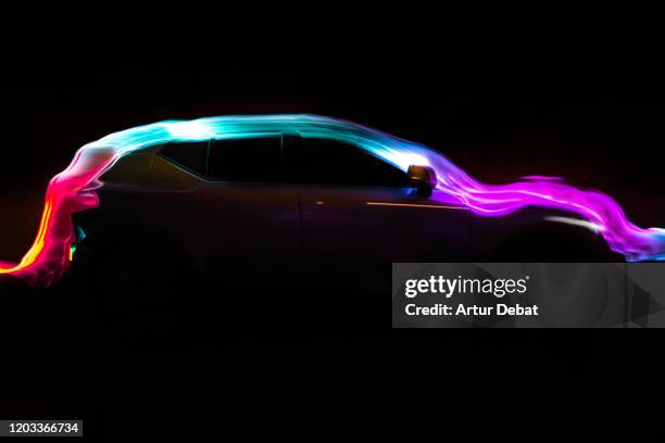 modern car with aerodynamic colorful light trail at night. - car safety stock pictures, royalty-free photos & images