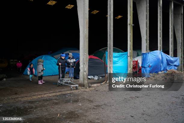 Migrant children from Iraq and Iran camp in a derelict industrial building on February 01, 2020 in Dunkirk, France. Migrants are still hopeful of...