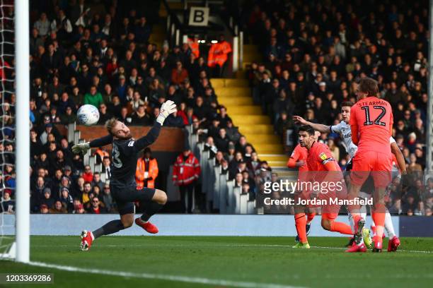 Tom Cairney of Fulham scores his sides second goal past Joel Coleman of Huddersfield Town during the Sky Bet Championship match between Fulham and...