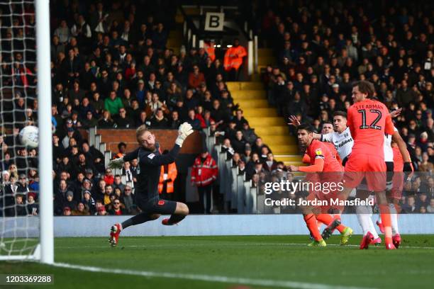 Tom Cairney of Fulham scores his sides second goal past Joel Coleman of Huddersfield Town during the Sky Bet Championship match between Fulham and...