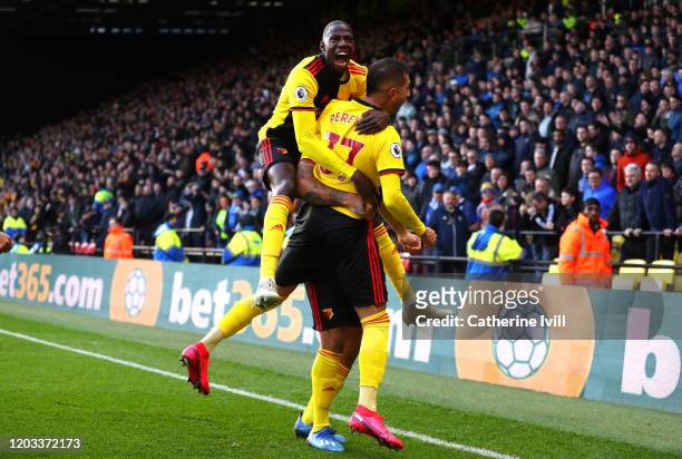 Roberto Pereyra of Watford celebrates with Abdoulaye Doucoure after scoring his team's second goal during the Premier League match between Watford FC...