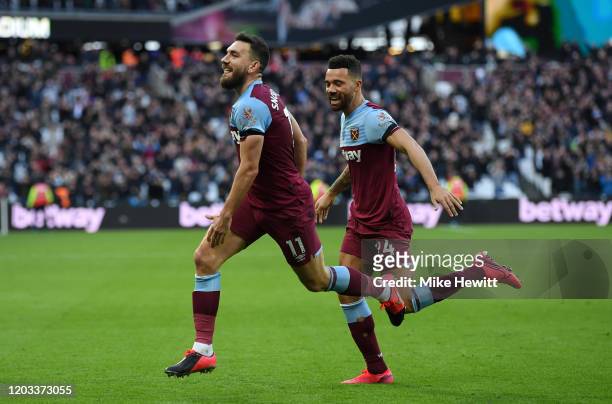 Robert Snodgrass of West Ham United celebrates with Ryan Fredericks after scoring his team's second goal during the Premier League match between West...