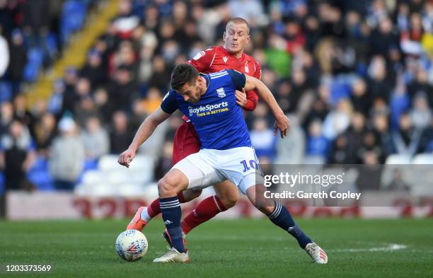 Lukas Jutkiewicz of Birmingham City is tackled by Ben Watson of Nottingham Forest during the Sky Bet Championship match between Birmingham City and...