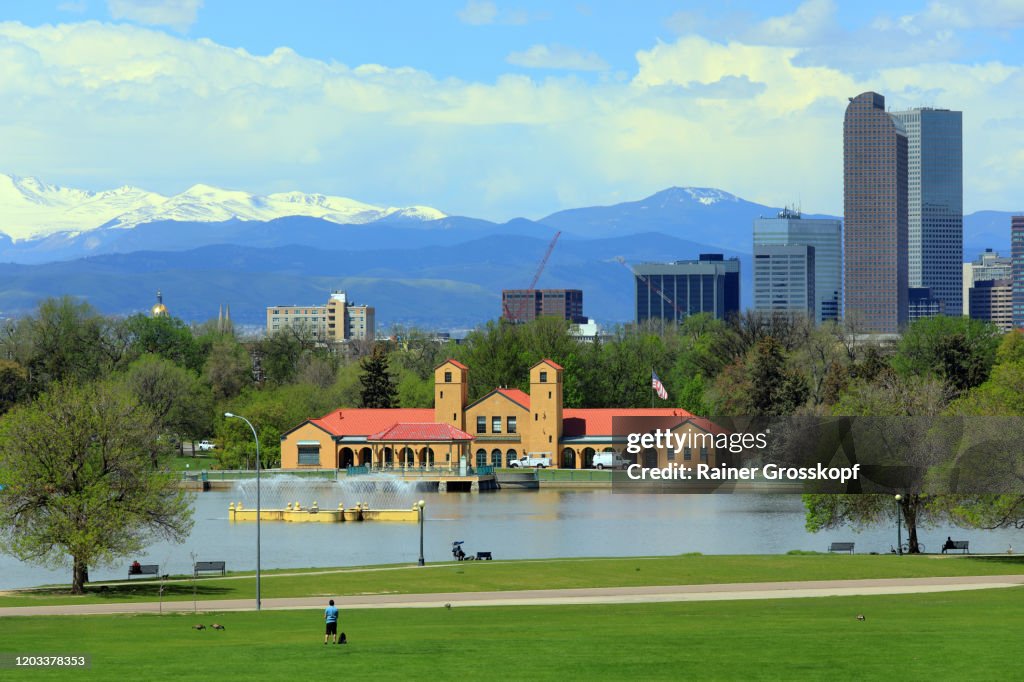 Lake in front of City Skyline with mountains in the background