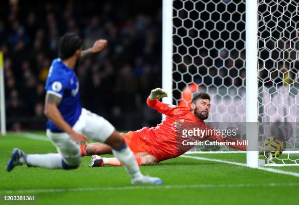 Theo Walcott of Everton scores his team's third goal past Ben Foster of Watford during the Premier League match between Watford FC and Everton FC at...