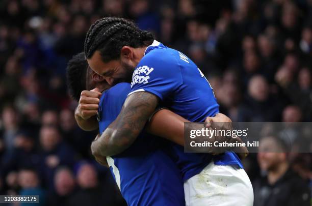 Theo Walcott of Everton celebrates with Yerry Mina after scoring his team's third goal during the Premier League match between Watford FC and Everton...