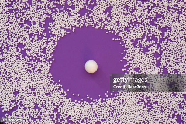 small polystyrene balls on purple background - tenue de protection fotografías e imágenes de stock