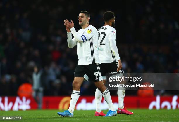 Aleksandar Mitrovic and Cyrus Christie of Fulham celebrate at full-time during the Sky Bet Championship match between Fulham and Huddersfield Town at...