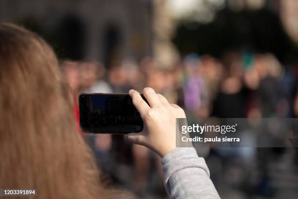 woman is recording a feminist flash mob - flash mob stock pictures, royalty-free photos & images