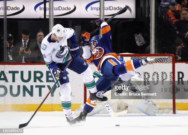 Tyler Myers of the Vancouver Canucks steps into Brock Nelson of the New York Islanders during the first period at the Barclays Center on February 01,...