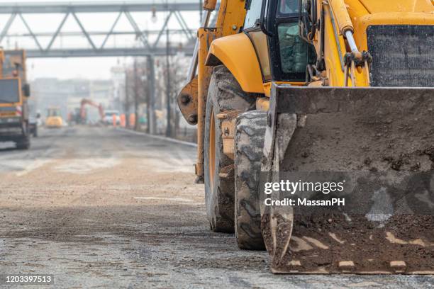 detail of excavator on an urban construction site - bulldozer stock pictures, royalty-free photos & images