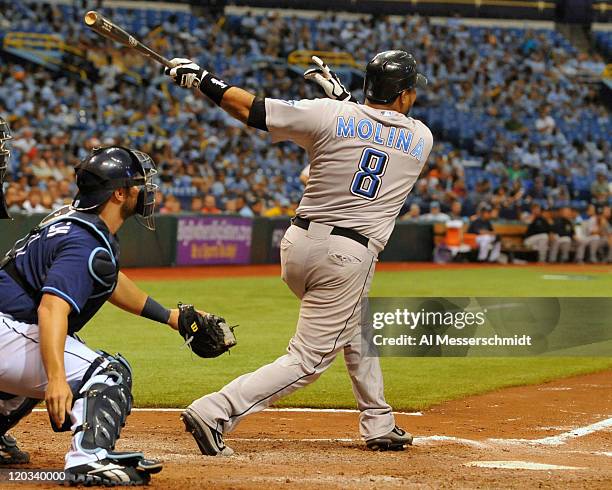 Catcher Jose Molina of the Toronto Blue Jays triples to drive in two runs in the 11th inning against the Tampa Bay Rays August 4, 2011 at Tropicana...