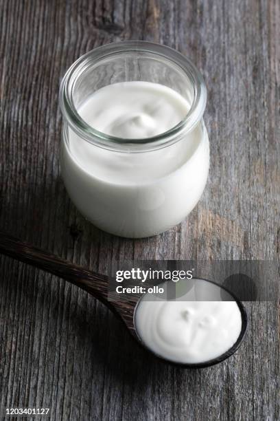 yoghurt pot, wooden table background - yoghurt pot stock pictures, royalty-free photos & images