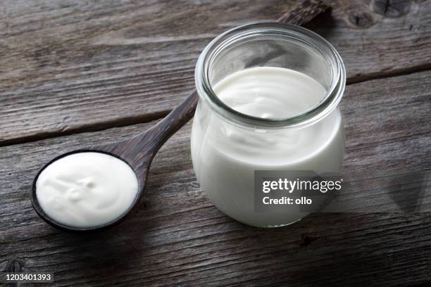 yoghurt pot, wooden table background - yogurt container stock pictures, royalty-free photos & images