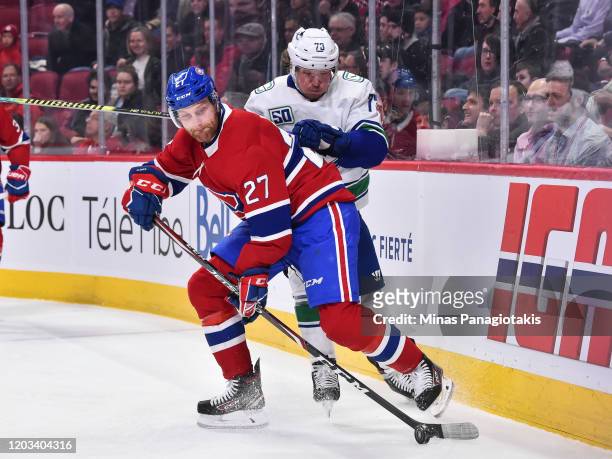 Karl Alzner of the Montreal Canadiens defends the puck from Tyler Toffoli of the Vancouver Canucks during the first period at the Bell Centre on...