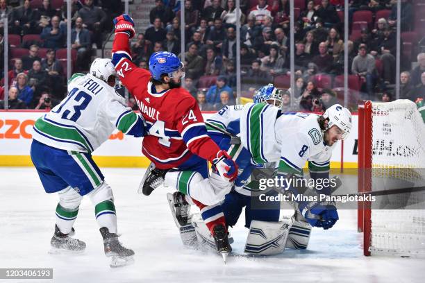 Phillip Danault of the Montreal Canadiens and Christopher Tanev of the Vancouver Canucks lose their balance during the second period at the Bell...