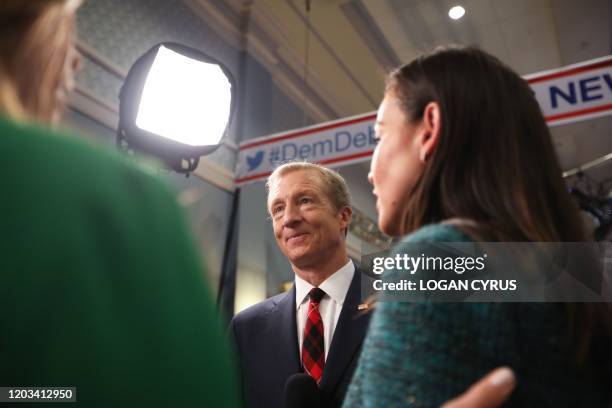 Democratic presidential hopeful billionaire activist Tom Steyer gives an interview in the spin room after participating in the tenth Democratic...
