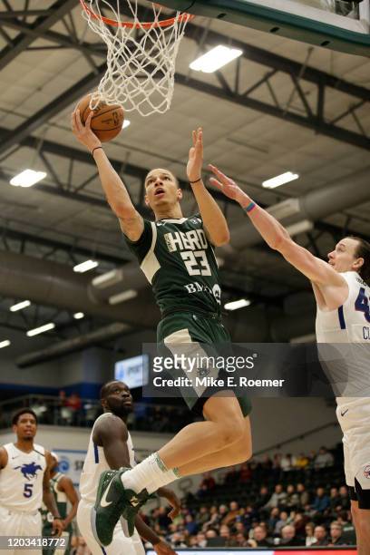 February 25: Wisconsin Herd forward D.J. Wilson shoot the ball as Delaware Blue Coats center Dennis Clifford defends in a NBA G-League game on...