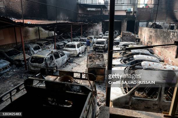 General view of a parking with burnt-out vehicles is pictured following clashes between people supporting and opposing a contentious amendment to...
