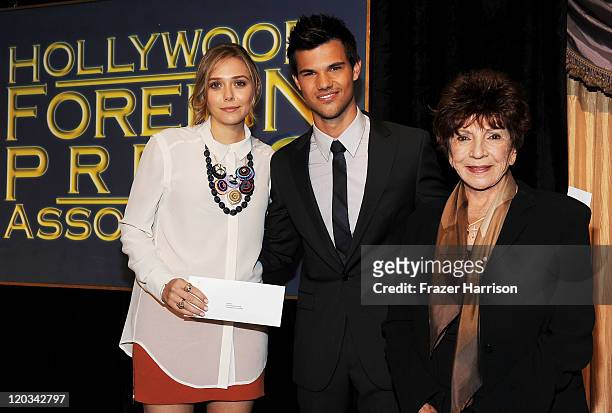 Actress Elizabeth Olsen, actor Taylor Lautner and Aida Takla O'Reilly, President of the Hollywood Foreign Press Association, attend the Presentation...