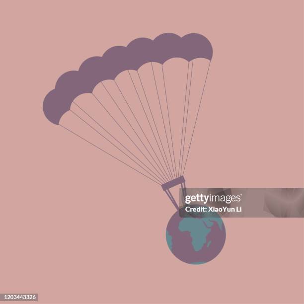 airdrop the earth using parachute. isolated on brown background. - paragliding stock illustrations